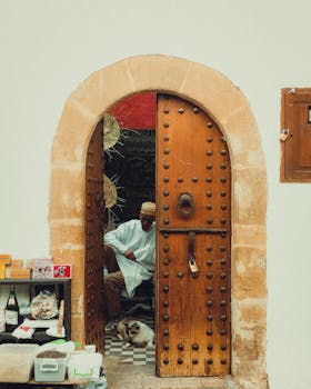 A candid moment at a traditional doorway in Rabat, Morocco, showcasing urban street life.
