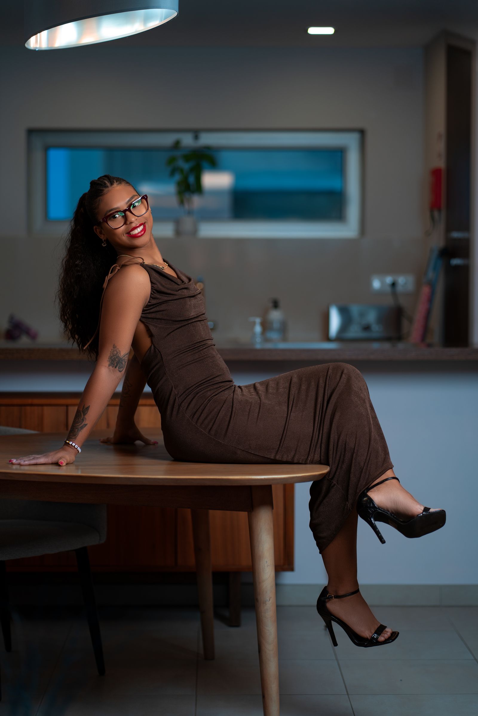 Elegant Woman Posing in Modern Indoor Setting · Free Stock Photo