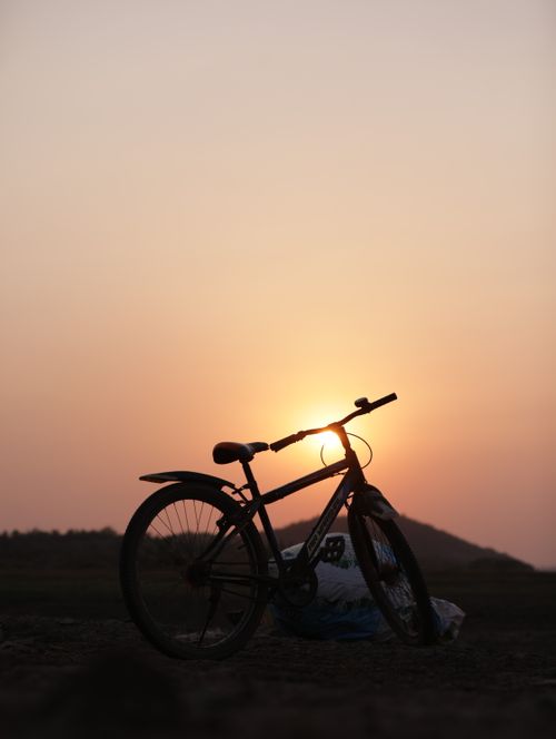 Free Captivating silhouette of a bicycle against the sunrise in Chhattisgarh, embodying tranquility and exploration. Stock Photo