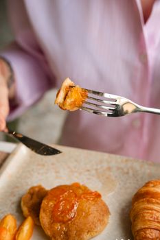 Close-up of a delicious brunch with pastries and jam on a plate.
