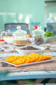 Bright and fresh breakfast setting featuring neatly sliced oranges on a table.