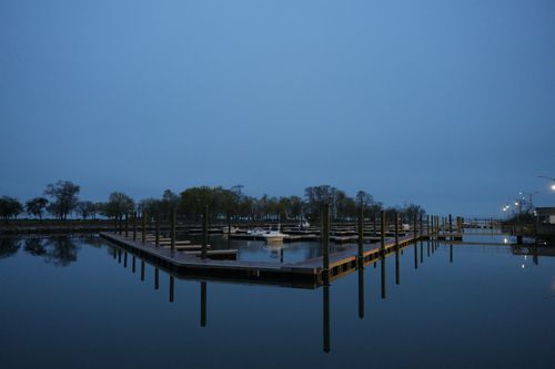 Free A tranquil marina scene at twilight in Stamford, Connecticut, showcasing calm waters and an empty dock. Stock Photo