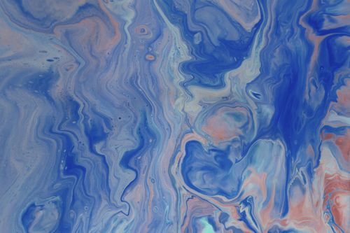 Free An artistic marbled texture with blue and pink swirls creating a fluid abstract design. Stock Photo