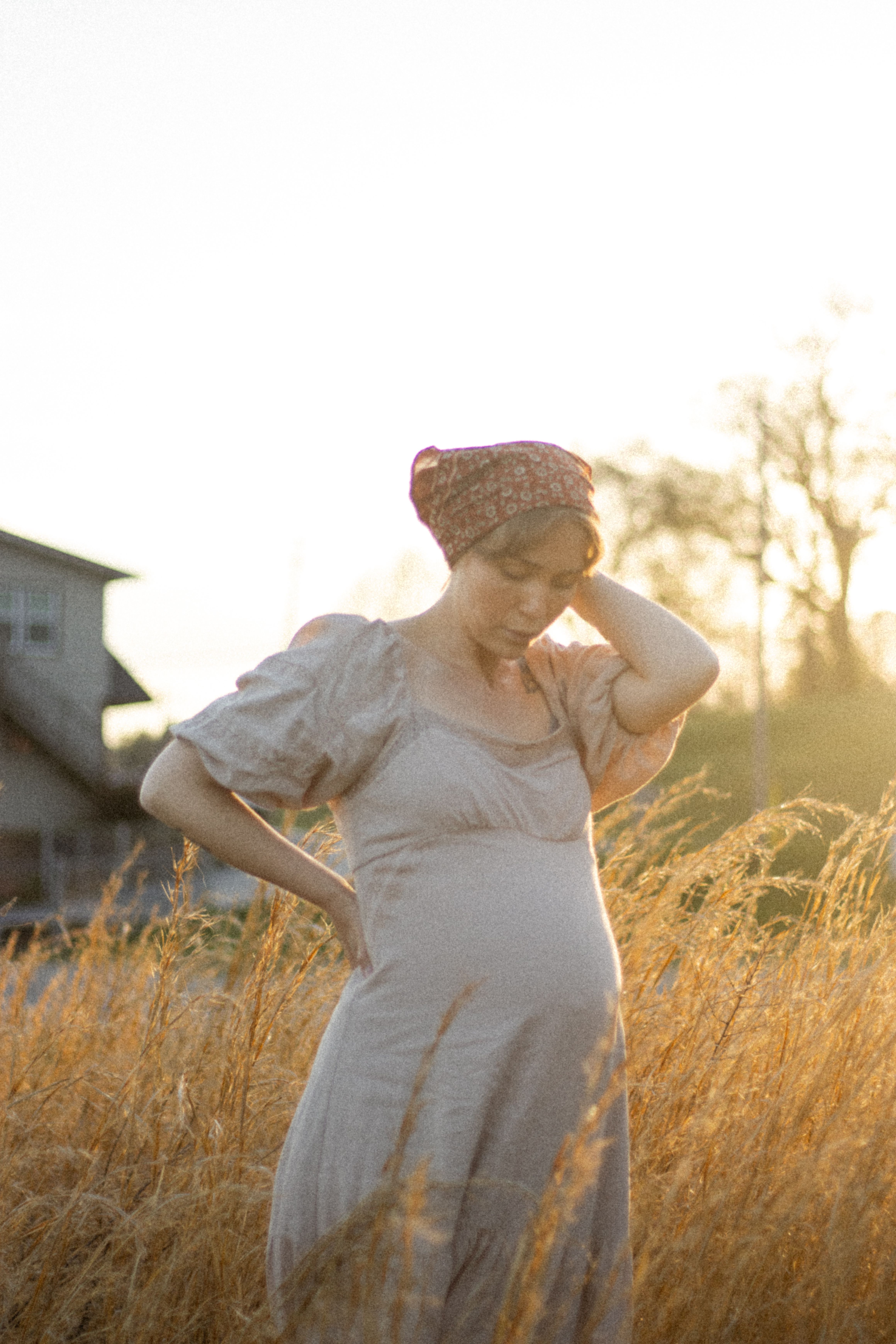 Serene Pregnant Woman in a Sunlit Field · Free Stock Photo