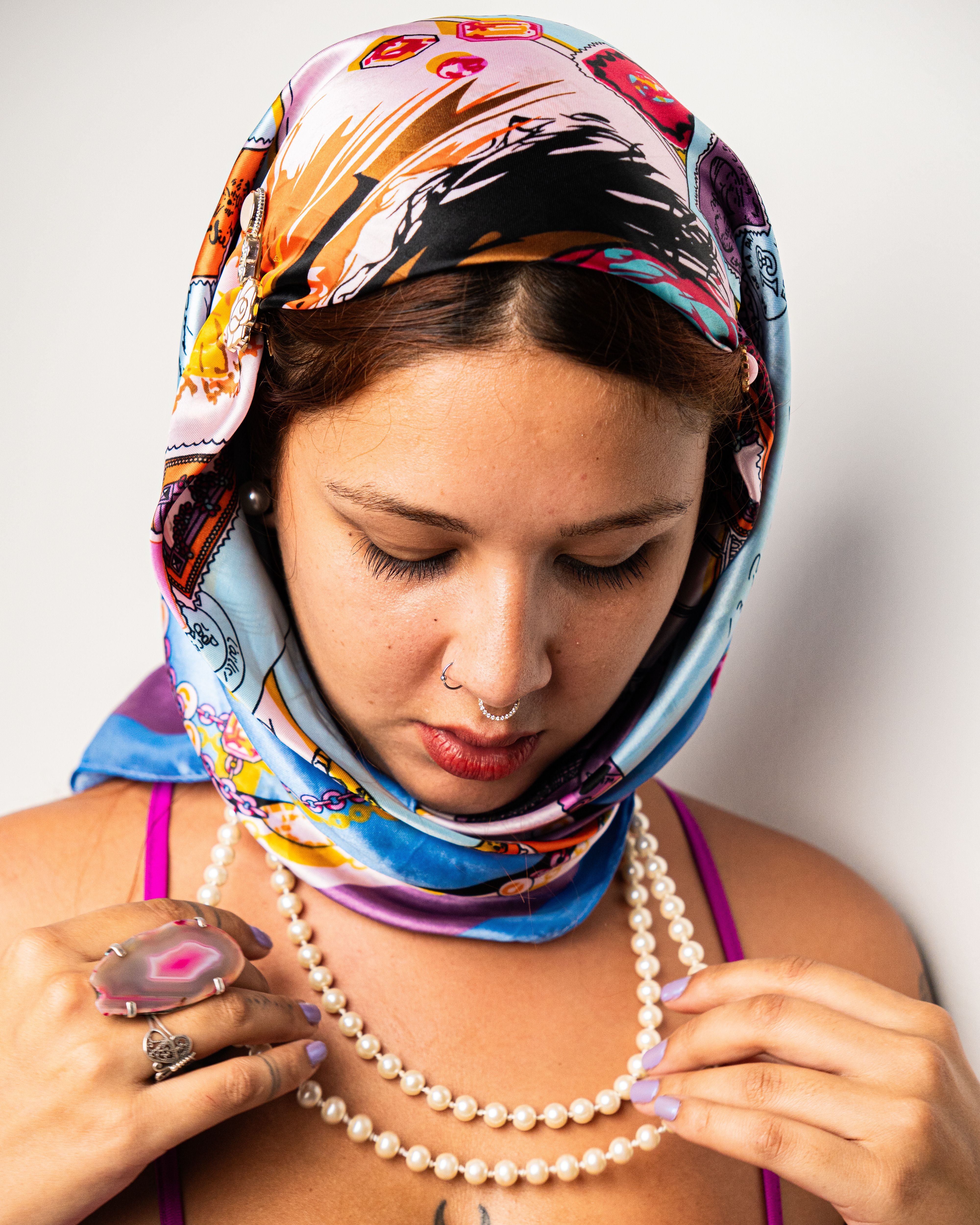 Elegant Woman in Colorful Headscarf and Pearls · Free Stock Photo