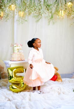 A delightful scene of a girl celebrating her birthday with balloons and cake indoors.