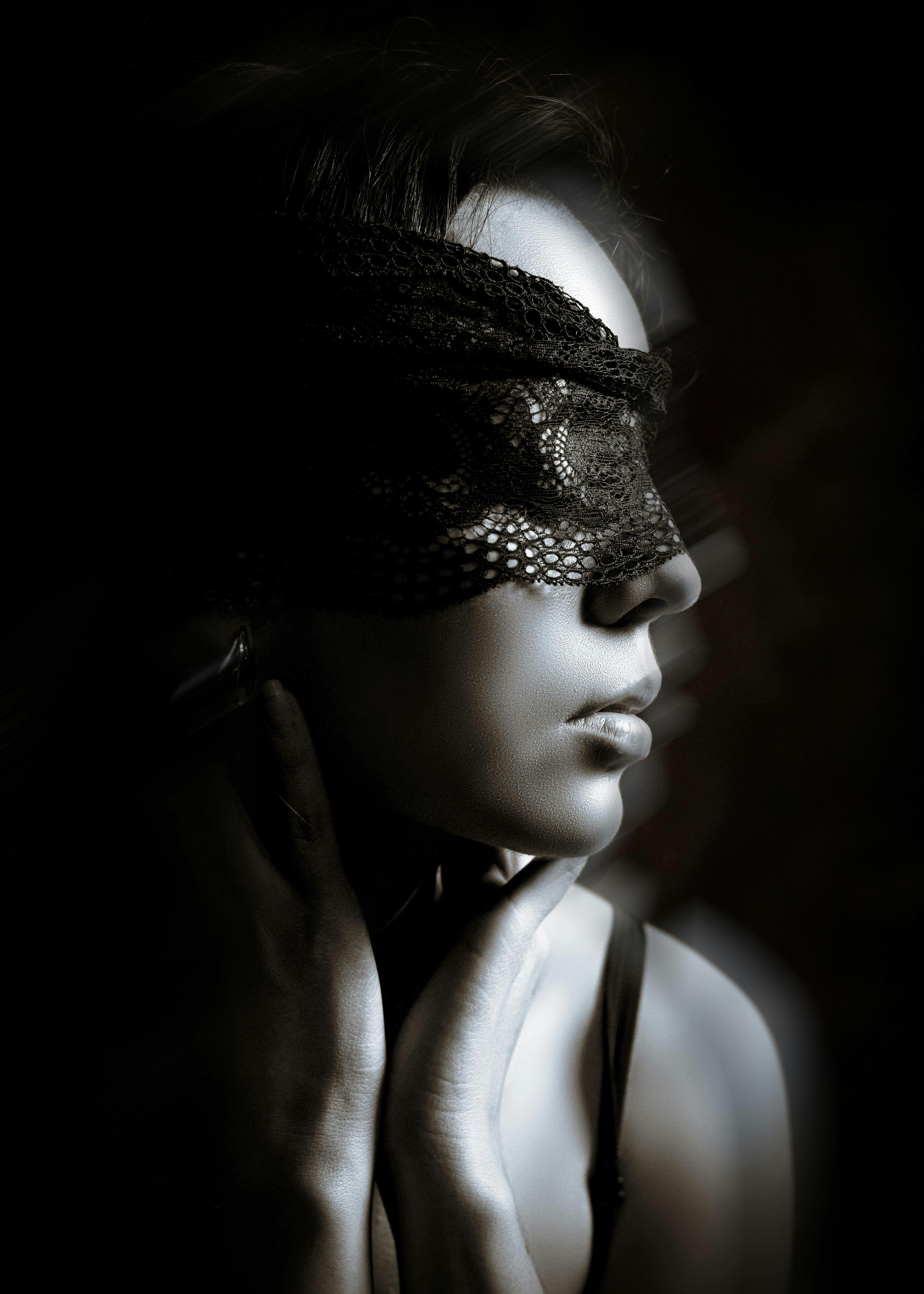 Artistic close-up of woman in lace blindfold, mysterious and elegant surrender, lips parted in deepening trance