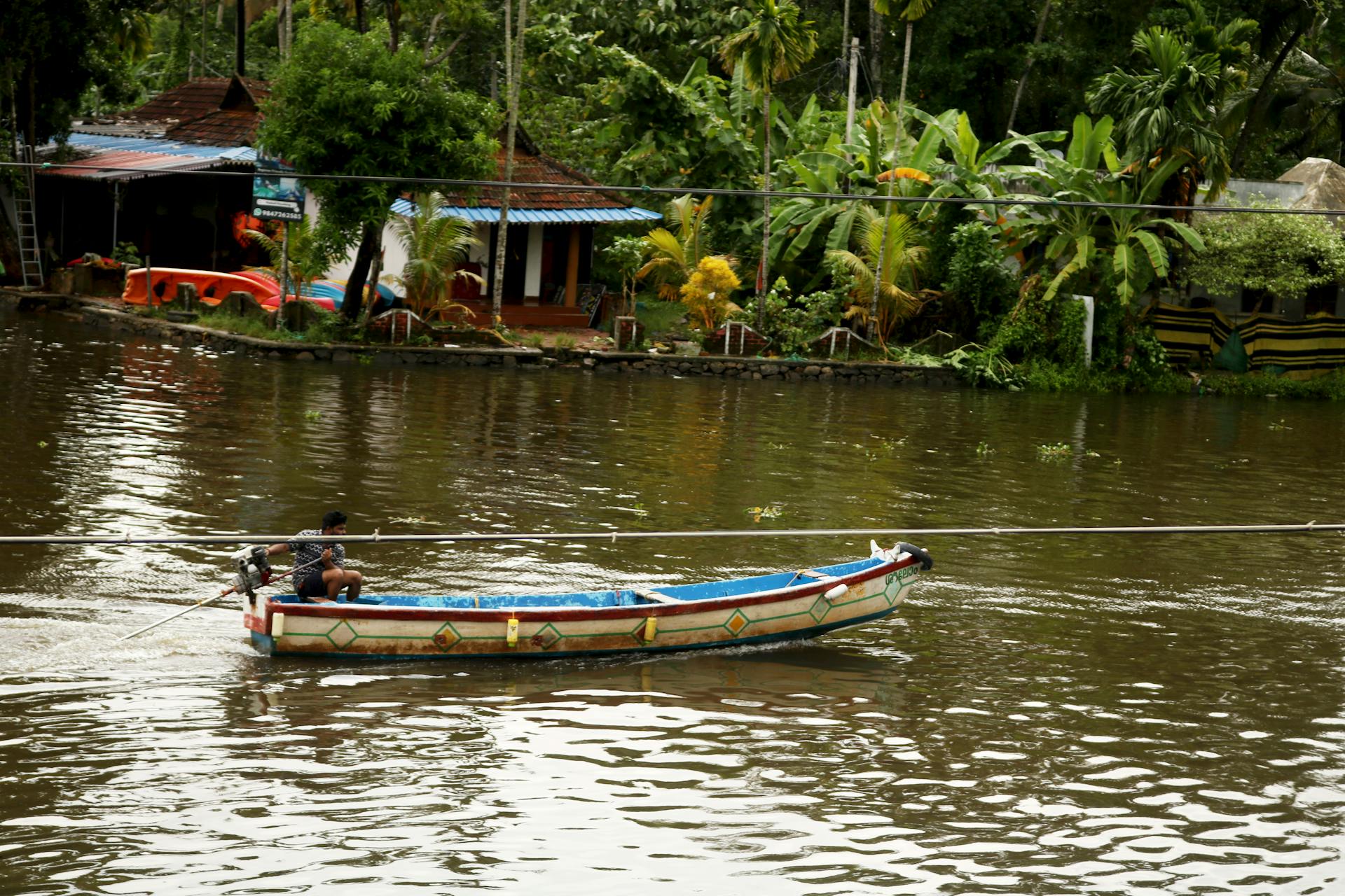 Experience the serene boat journey through the picturesque backwaters of Alappuzha, Kerala, India.