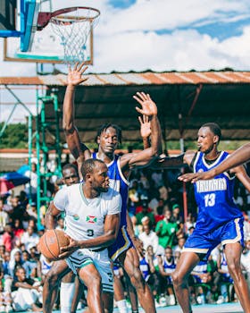 Action-packed local basketball game with determined players and cheering crowd.