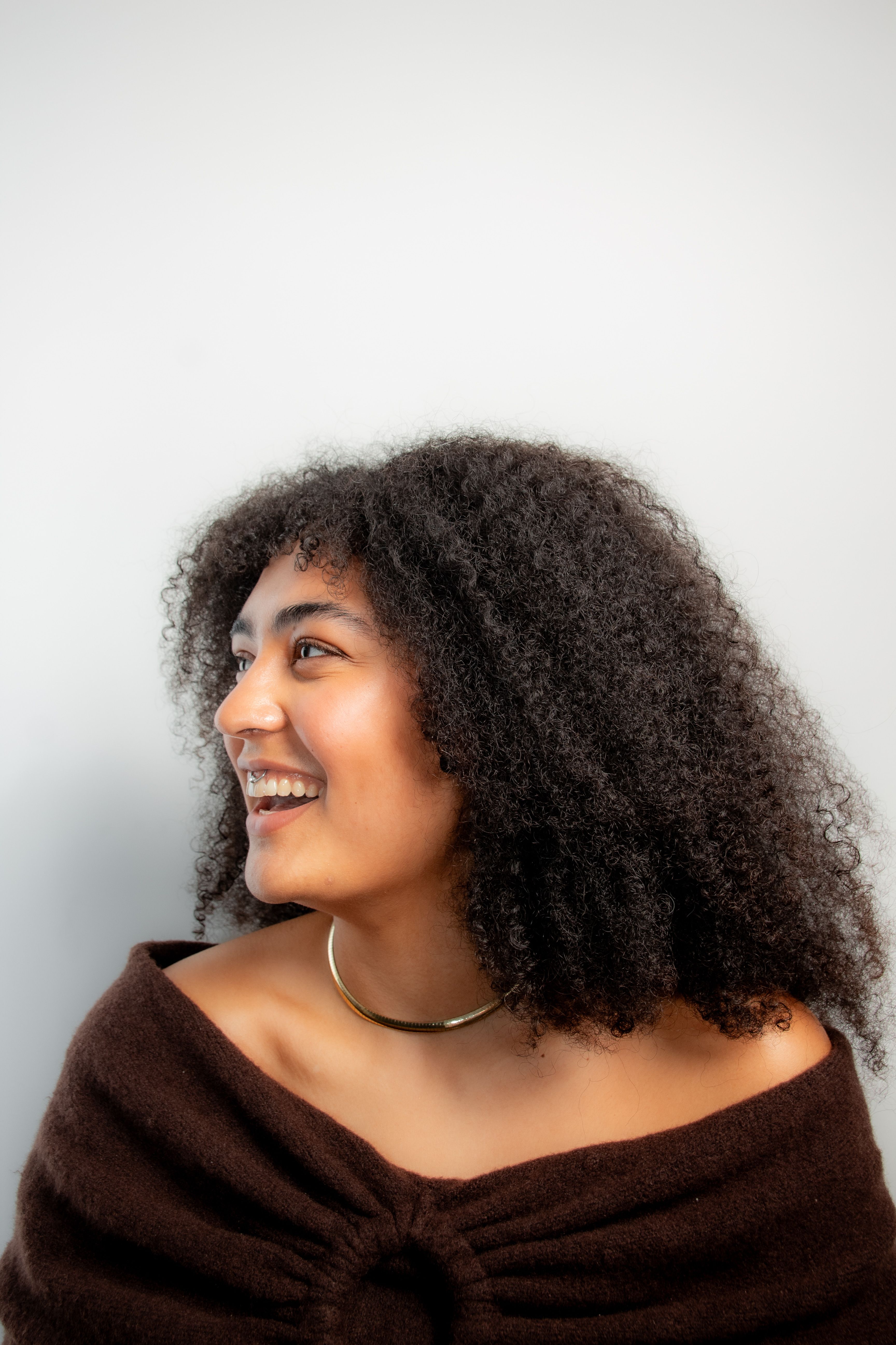 Smiling Woman with Curly Hair Portrait · Free Stock Photo