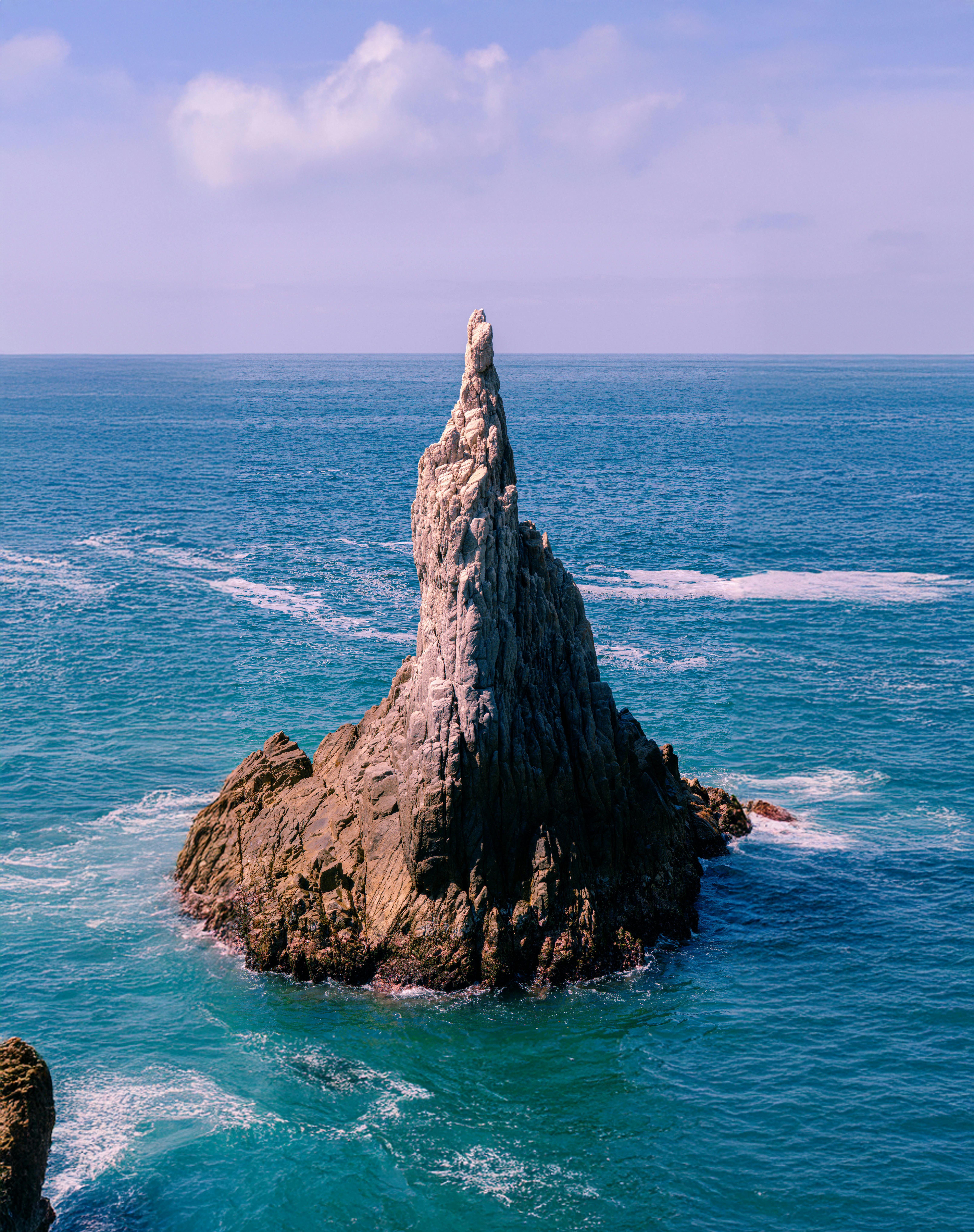 Stunning rock formation in the ocean at Maruata, Mexico, showcasing natural beauty and marine scenery.