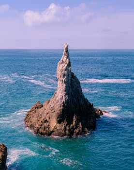 Stunning rock formation in the ocean at Maruata, Mexico, showcasing natural beauty and marine scenery.