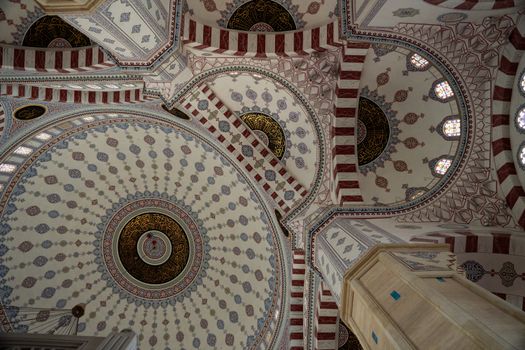 Explore the intricate patterns and design of a mosque ceiling dome captured in a stunning architectural photograph.