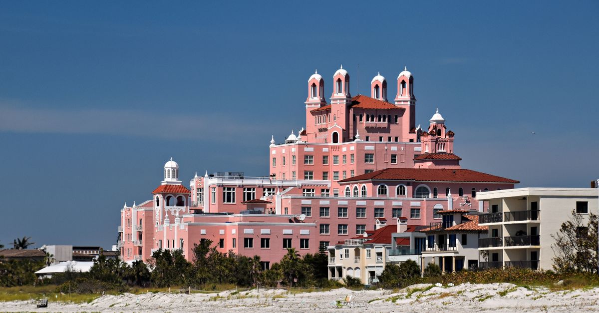 View of the iconic Don CeSar Hotel on St. Pete Beach against clear blue skies.