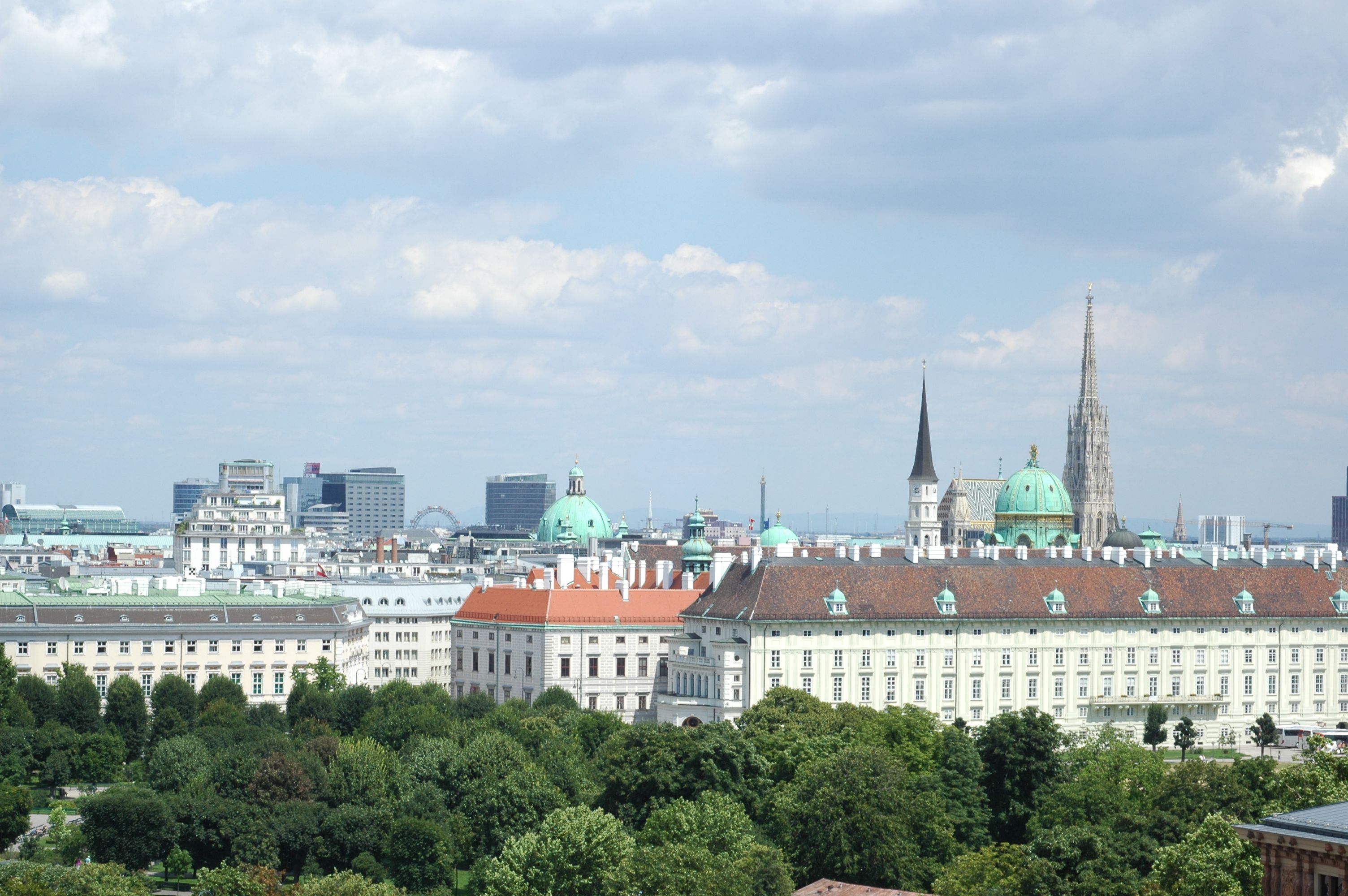 Aerial view of Vienna's iconic architecture including St. Stephen's Cathedral and Hofburg Palace.