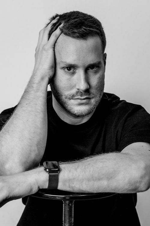 Free Black and white portrait of a contemplative man resting his head on his hand. Stock Photo