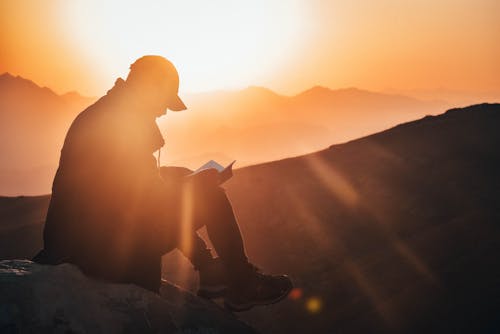 Silhouette Photography of Man Sitting 