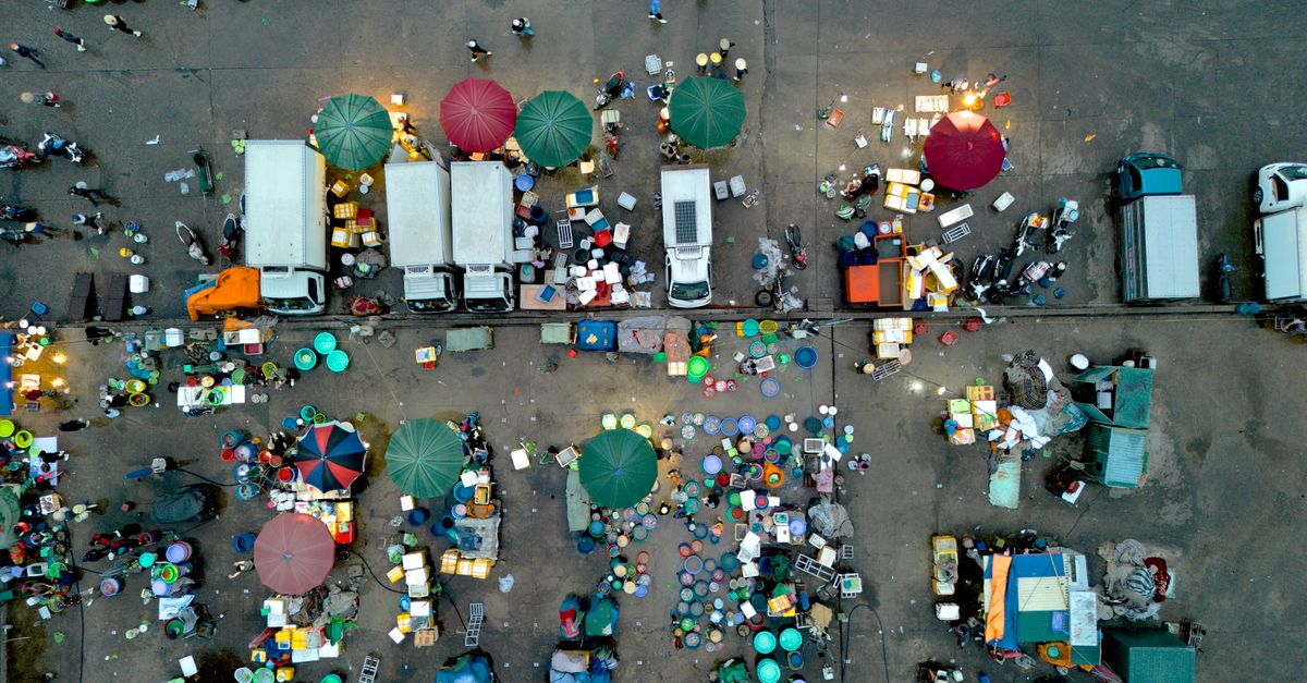 Ho Market in Ghana bustling with vendors and shoppers on a Sunday afternoon