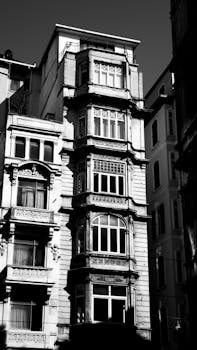 Elegant vintage architecture in black and white emphasizing intricate facade details.