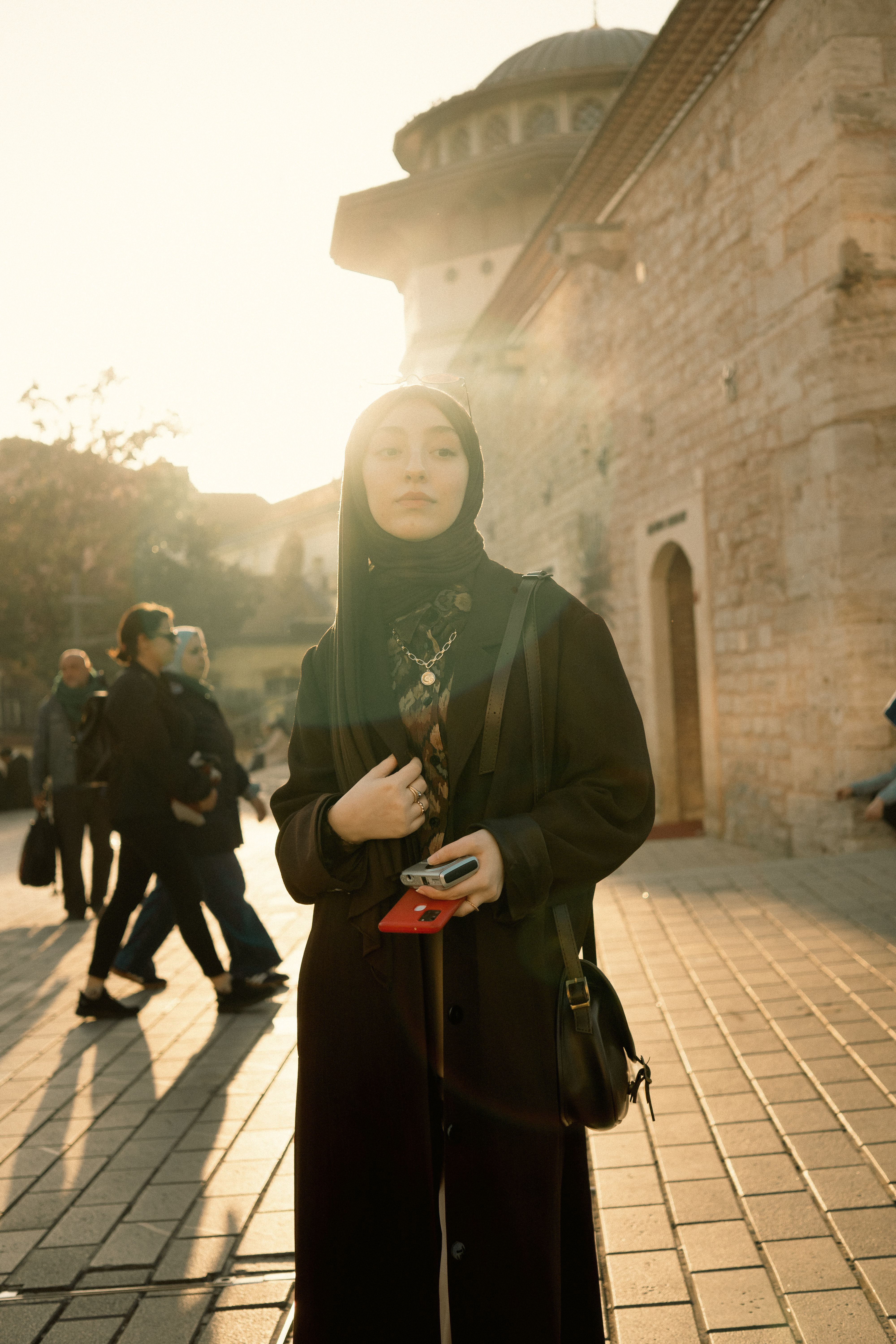 Woman in Hijab by Historic Mosque at Sunset · Free Stock Photo