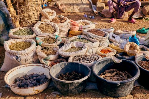 Free Colorful display of spices and herbs in an outdoor market setting, perfect for culinary enthusiasts. Stock Photo