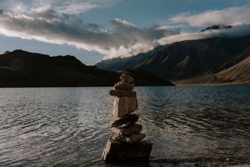 Free Calm waters and a rock stack at Marango Rangarik, Himachal Pradesh, India. Stock Photo
