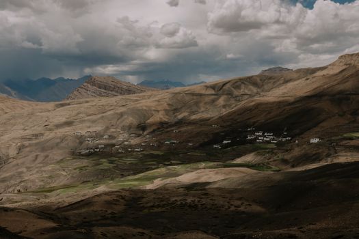 A stunning aerial shot of Spiti Valley's dramatic mountains and landscapes under a cloudy sky.