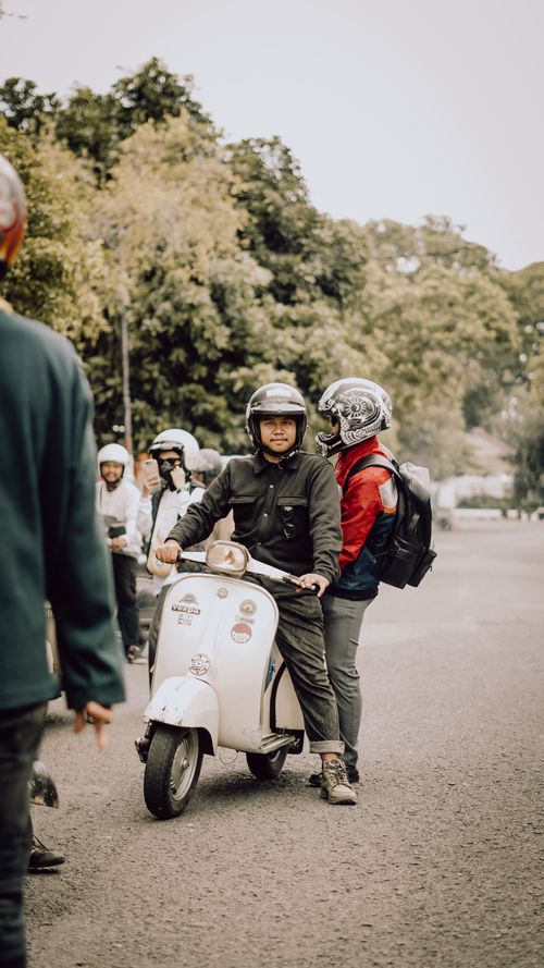 Free Group of people riding scooters in East Java, Indonesia, enjoying an outdoor gathering. Stock Photo