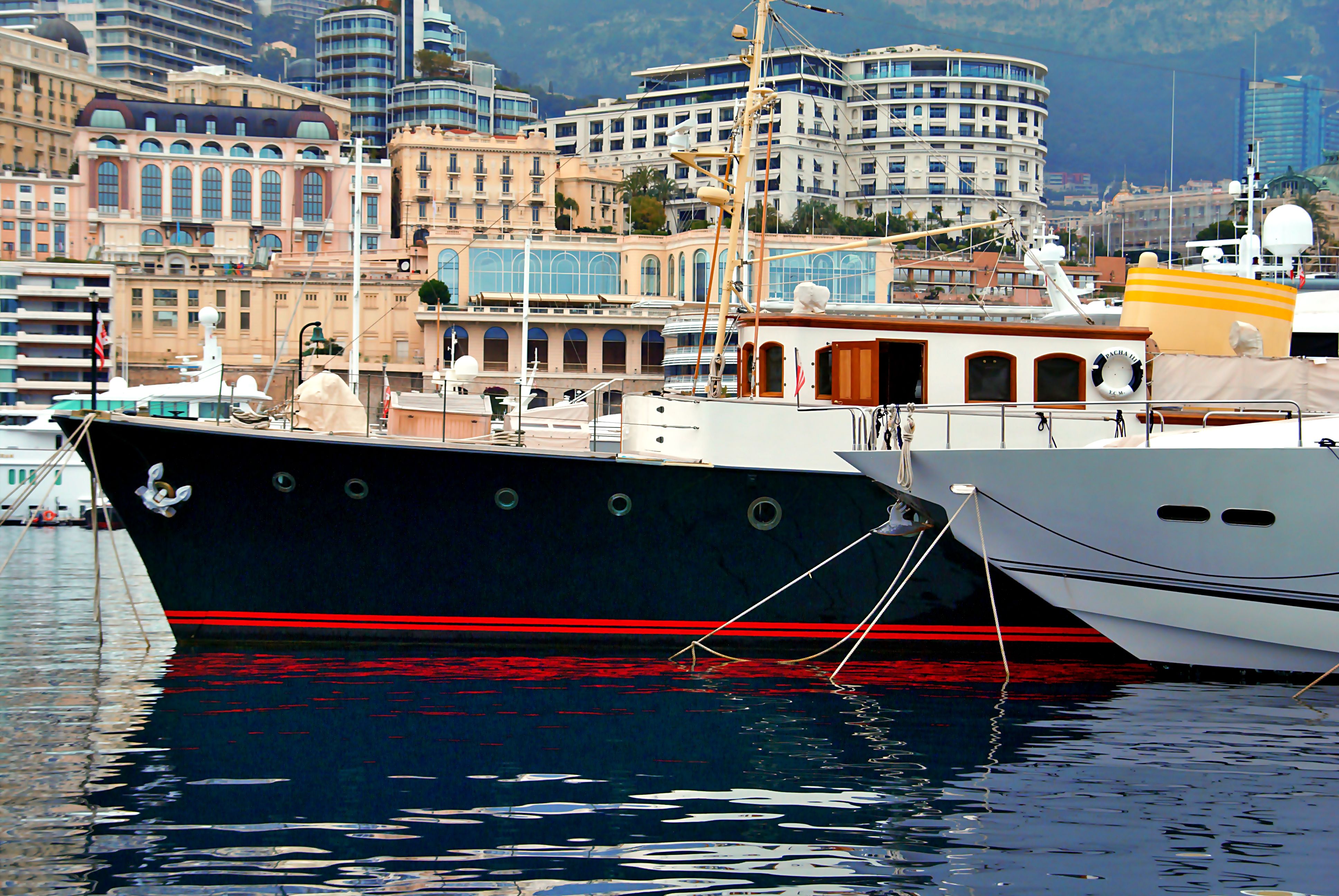 Unforgettable Full Day Private Trip of Saint Tropez from Monaco Review 2026 - Elegant yachts docked at Monaco harbor with a stunning city backdrop showcasing luxurious architecture.