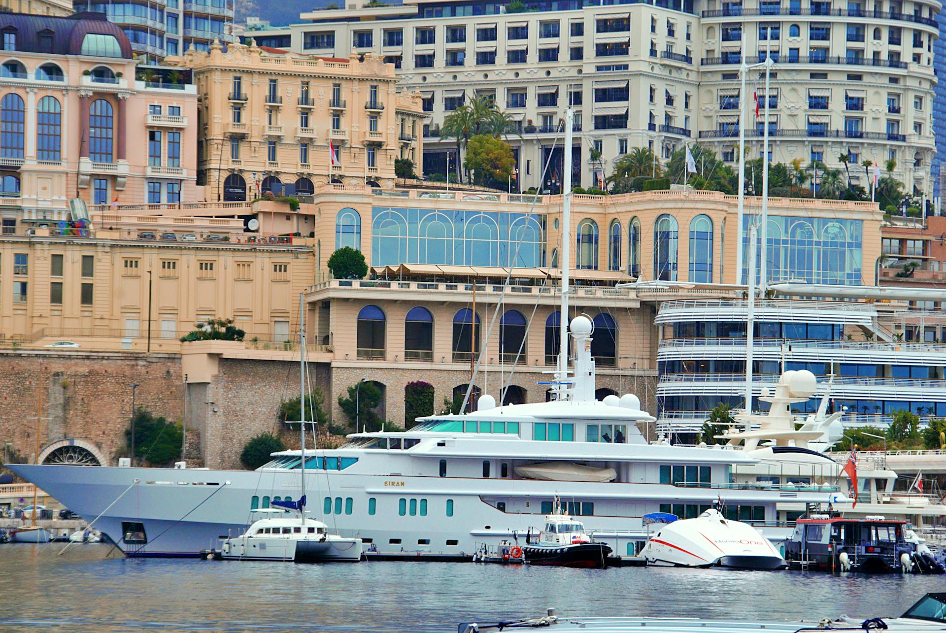 Stunning view of luxury yachts docked in Monaco harbor with elegant architecture in the backdrop.