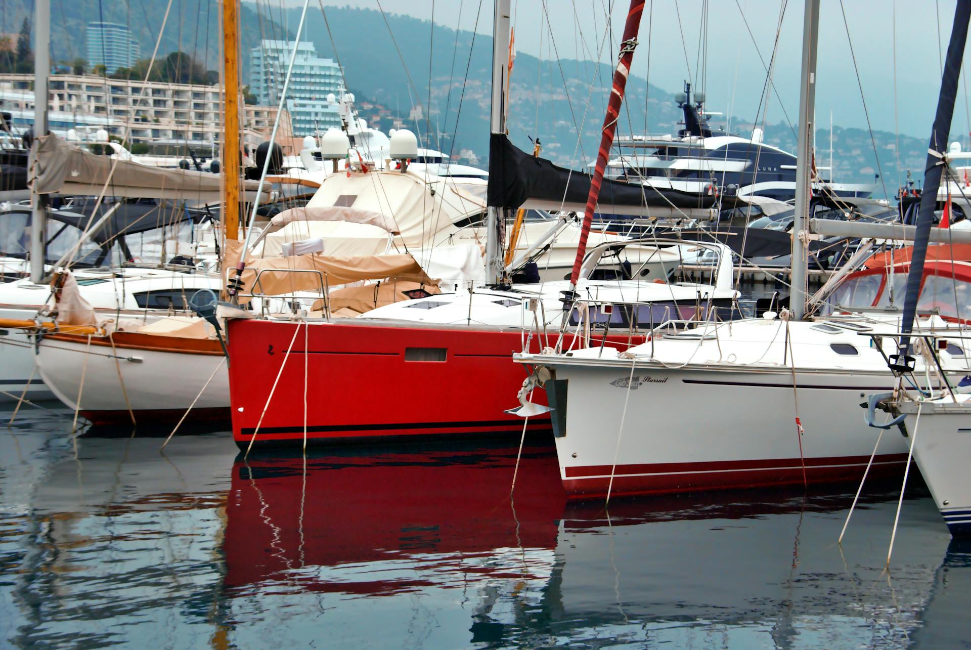 Vibrant yachts docked in the scenic Monaco harbor, showcasing luxury and maritime elegance.