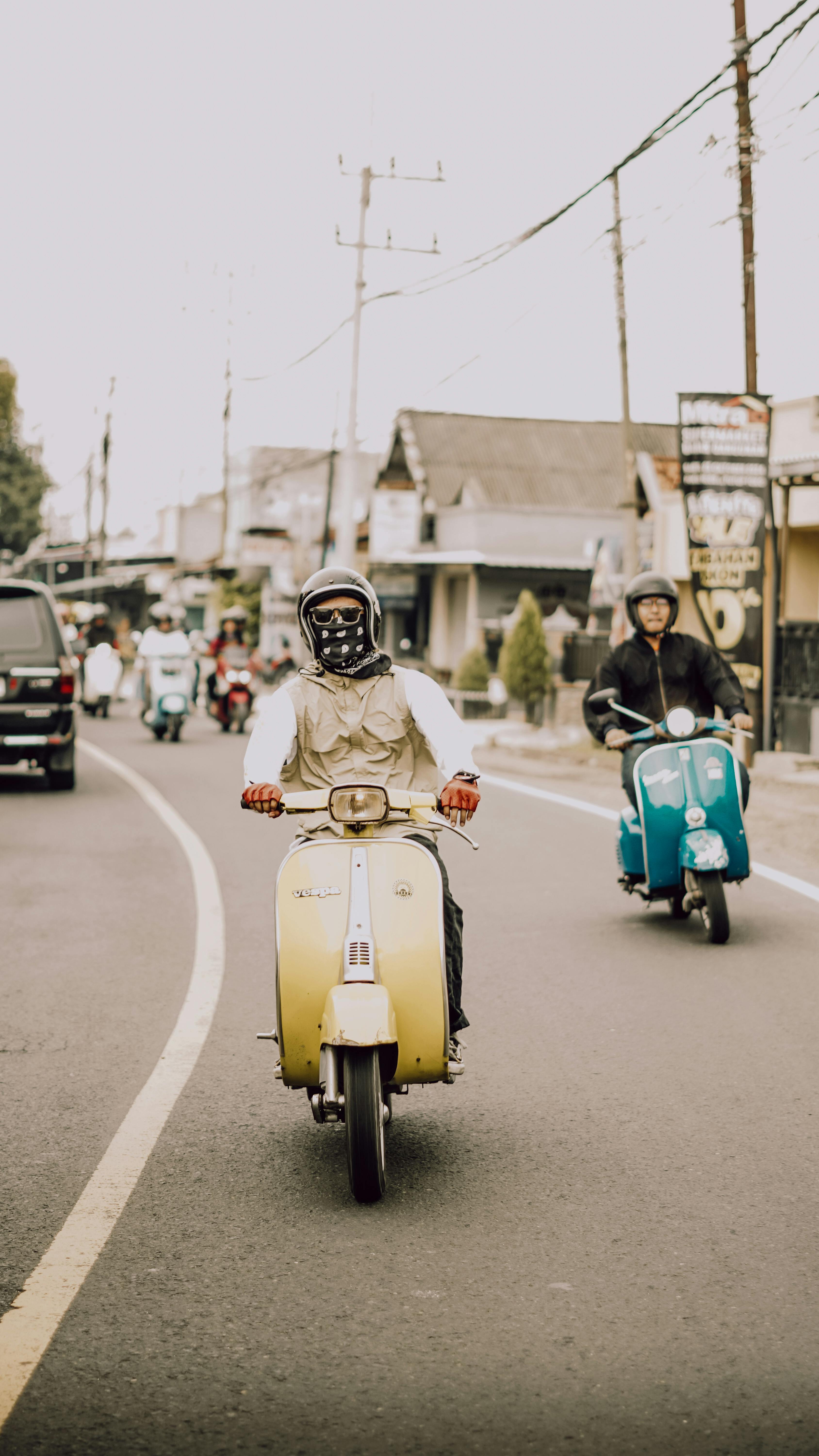 Free Vespa scooters on a lively street in East Java, Indonesia, capturing local culture and style. Bali scooter rental
