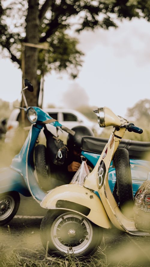 Free Vintage Vespa scooters parked outdoors in East Java, Indonesia, capturing a nostalgic street vibe. Stock Photo
