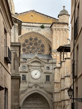 Capture the stunning Gothic architecture of Toledo Cathedral with its intricate facade and grand clock, a must-see Spanish landmark.