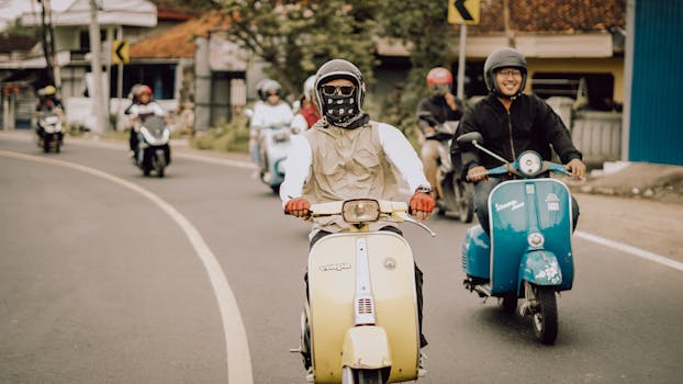 Group of friends enjoying a Vespa ride on a sunny day in East Java, Indonesia.