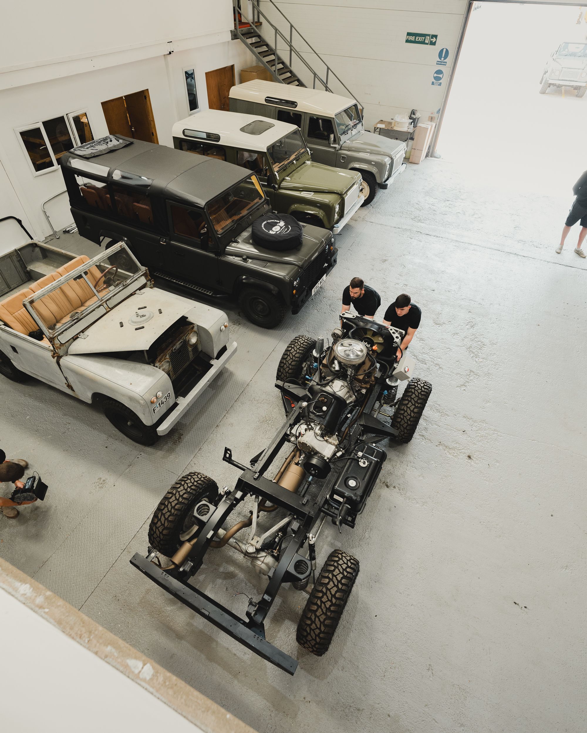 Mechanics Restoring Land Rover in Workshop · Free Stock Photo