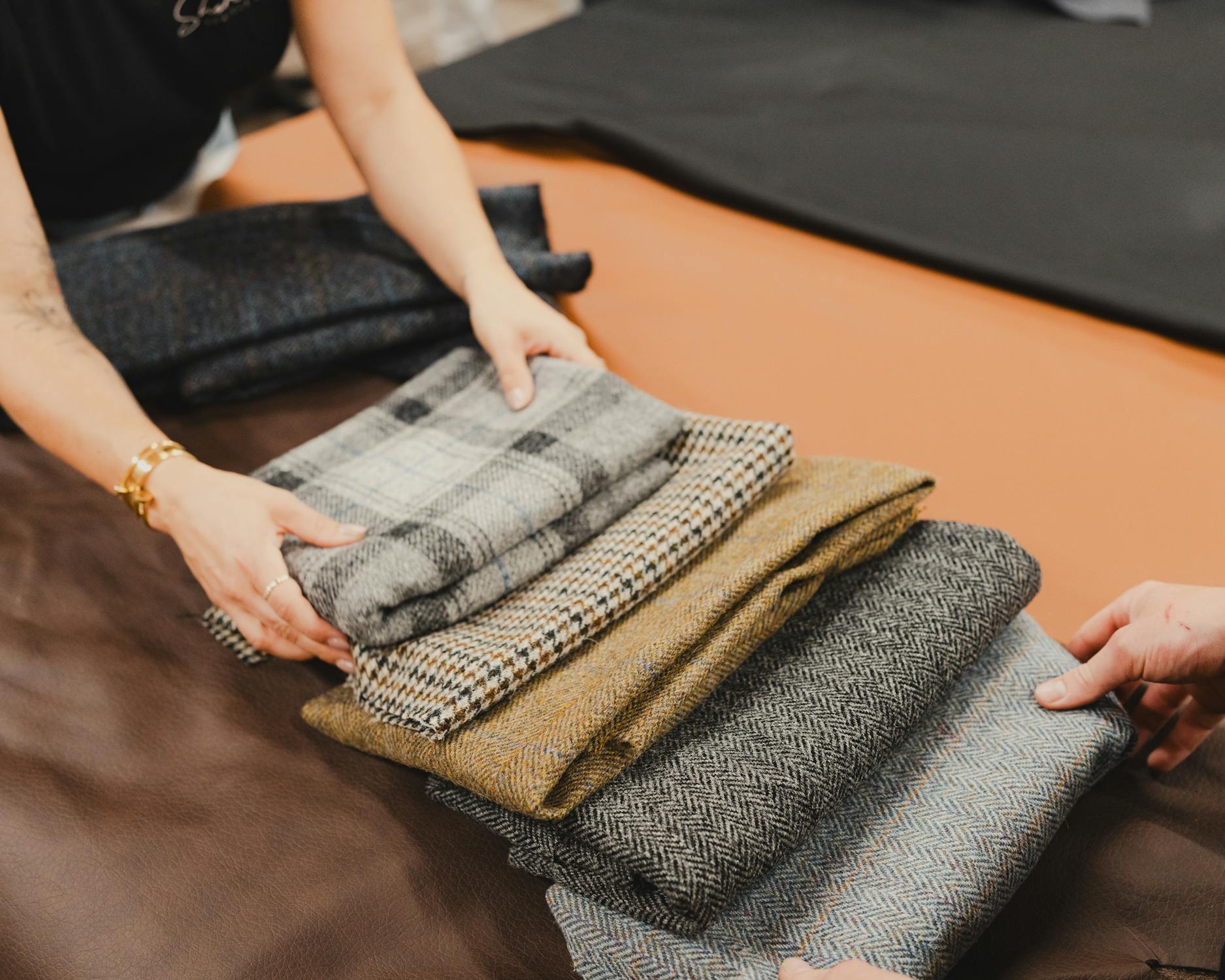 Tweed suit fabrics in different patterns such as check, houndstooth, and herringbone.