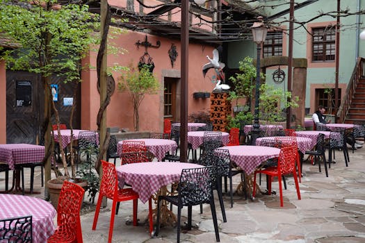 Charming outdoor cafe with vibrant tables and rustic ambiance, perfect for a cozy meal.