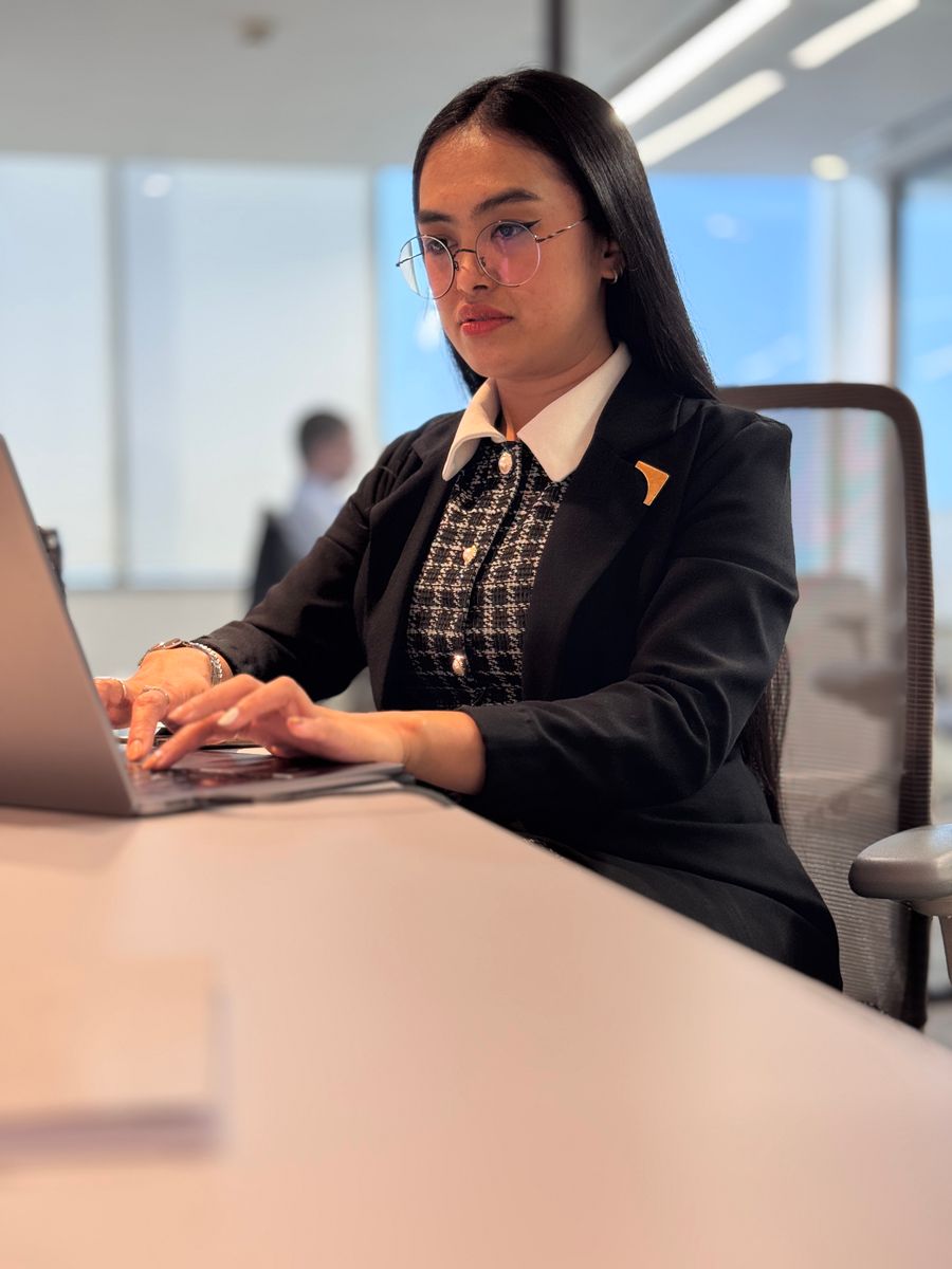 Professional woman working at a laptop in a modern office
