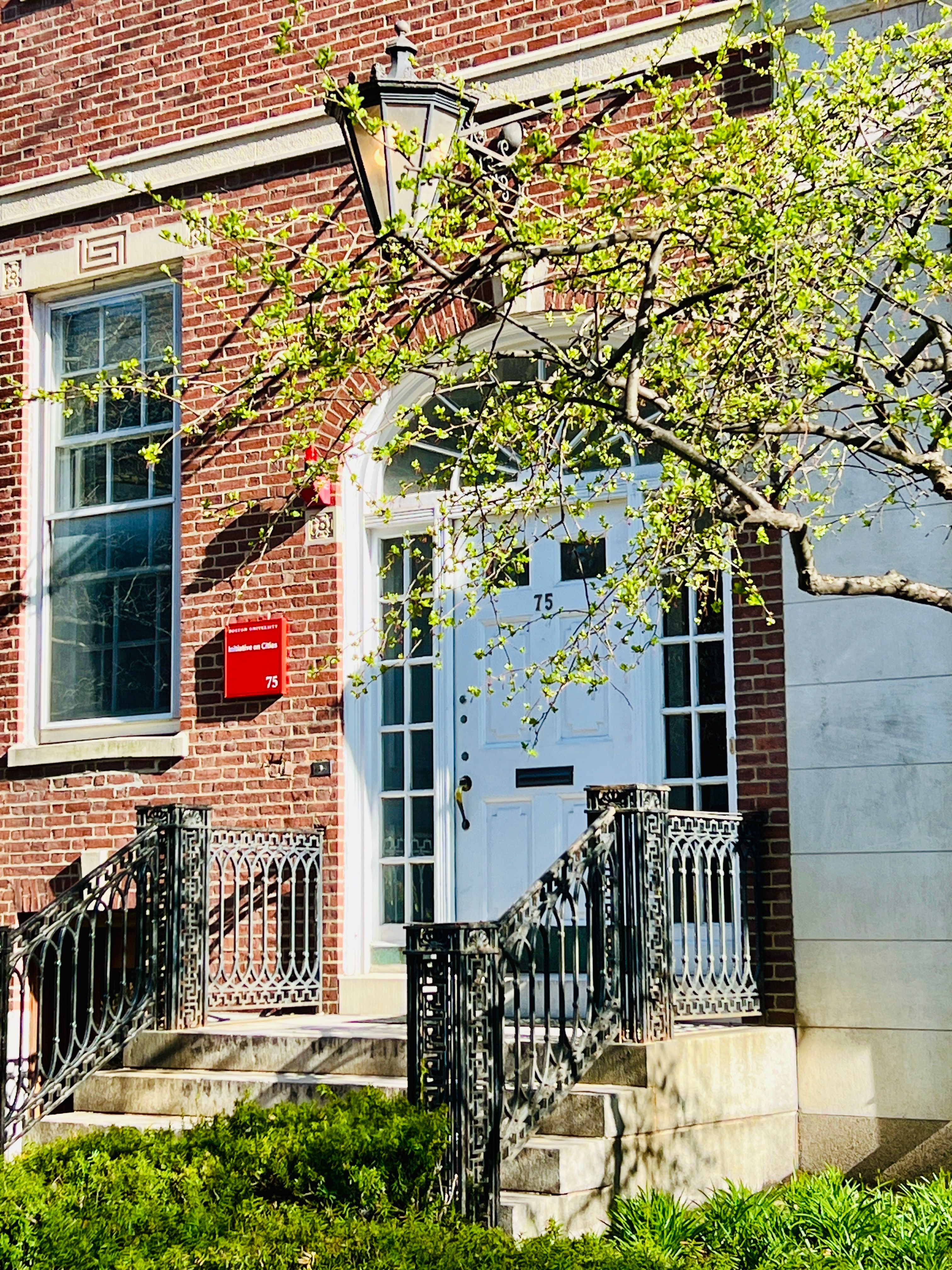 Charming Brick Building Entrance with Spring Foliage · Free Stock Photo