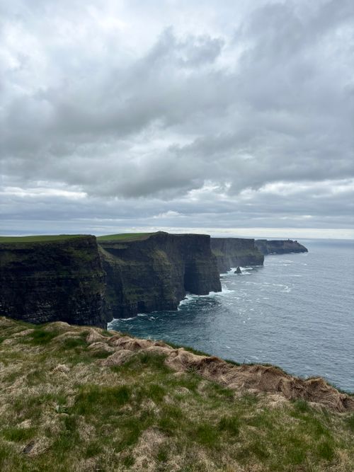 Free Captivating view of Ireland's Cliffs of Moher under an overcast sky, showcasing rugged beauty. Stock Photo