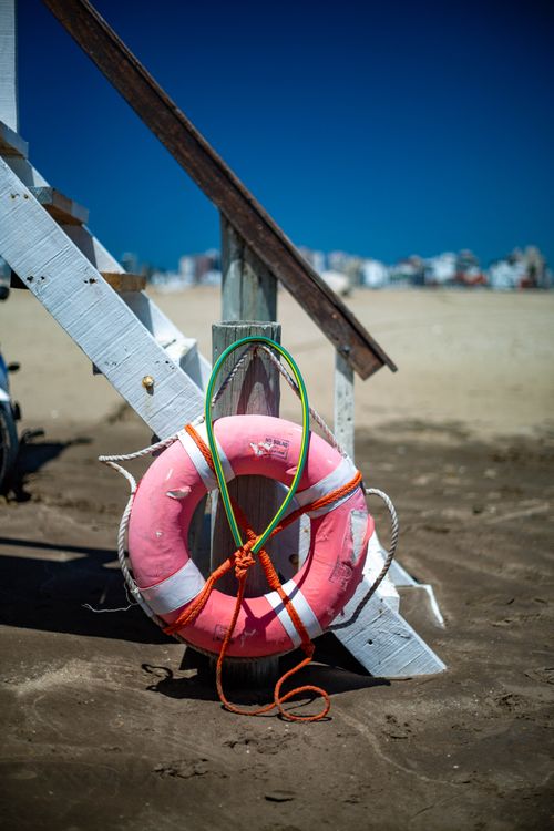 Free A vivid image of a pink lifebuoy at a lifeguard station on Mar del Plata, Argentina beach. Stock Photo