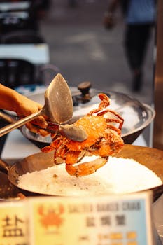Delicious salted egg crab being prepared in Kuala Lumpur's vibrant street market.