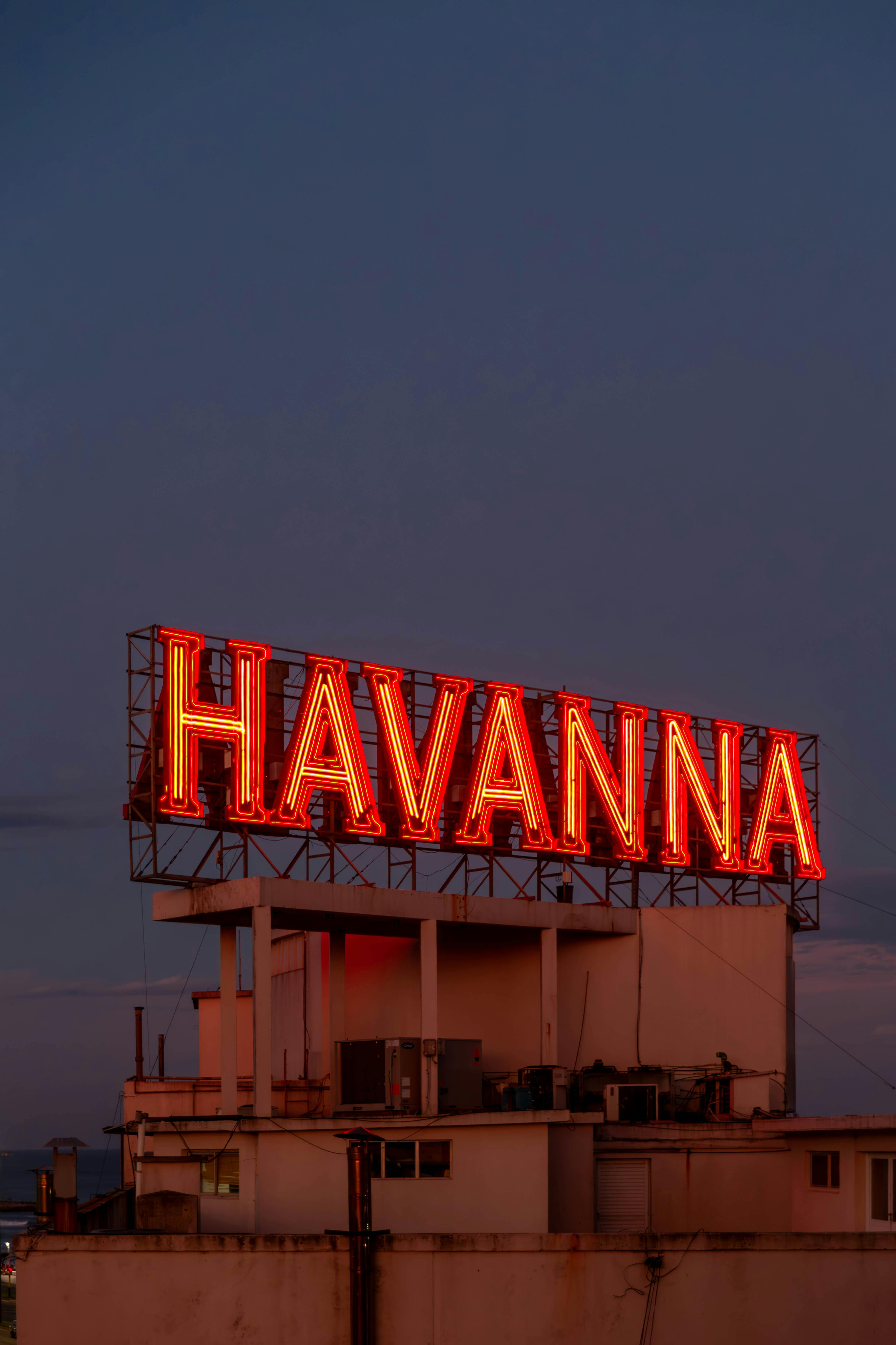 Striking neon Havanna sign illuminated against the evening sky in Mar del Plata, Argentina.
