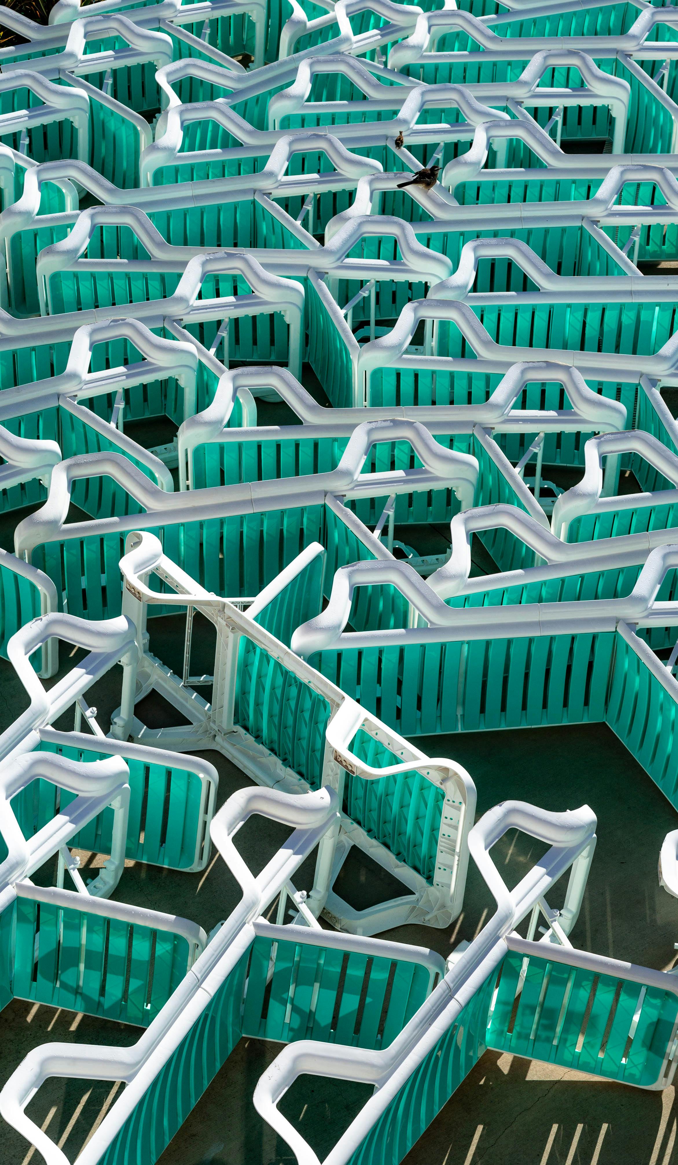Aerial shot of a vibrant turquoise outdoor maze in Mar del Plata, Argentina.
