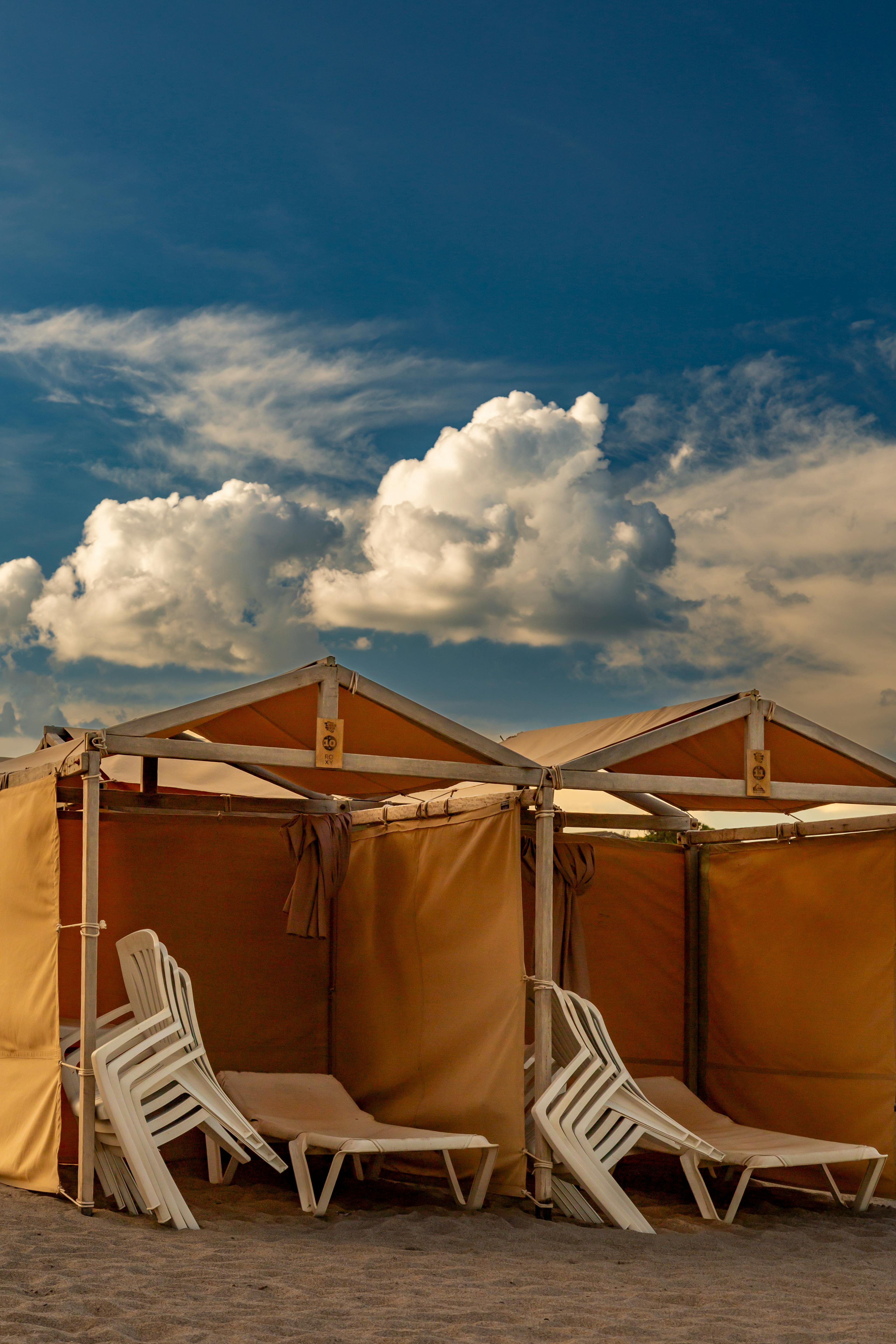 Relaxing beach cabanas at Mar del Plata with a scenic sky. Perfect for a peaceful vacation.
