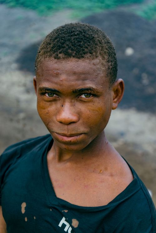 Free Close-up portrait of a young man with a neutral expression outdoors. Stock Photo