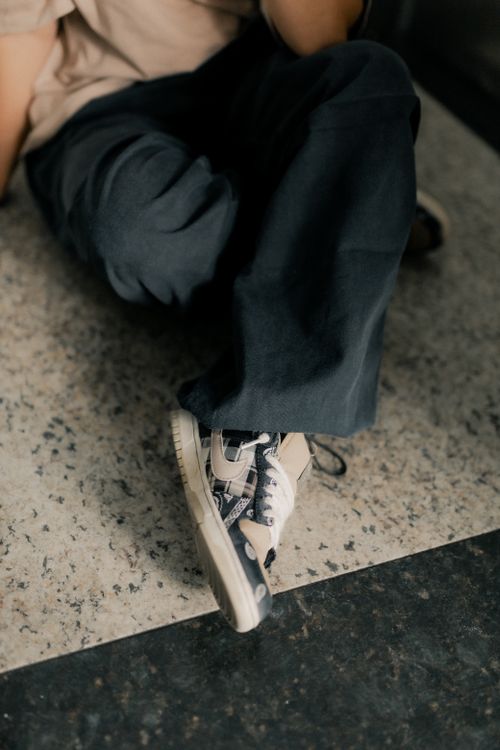 Free Close-up of stylish sneakers on a marble floor, showing casual fashion style. Stock Photo