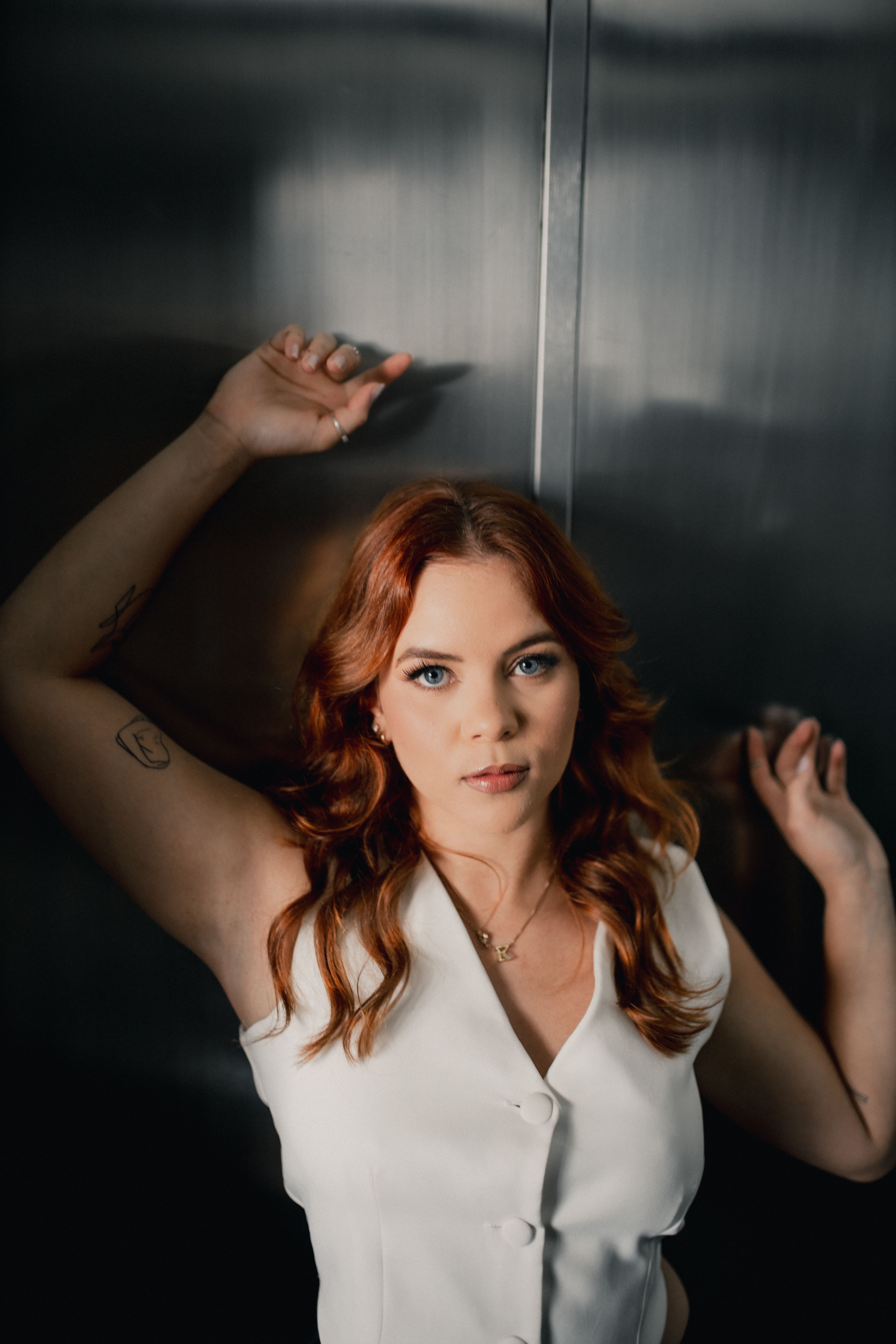 Portrait of a Woman with Red Hair in Stylish Attire · Free Stock Photo