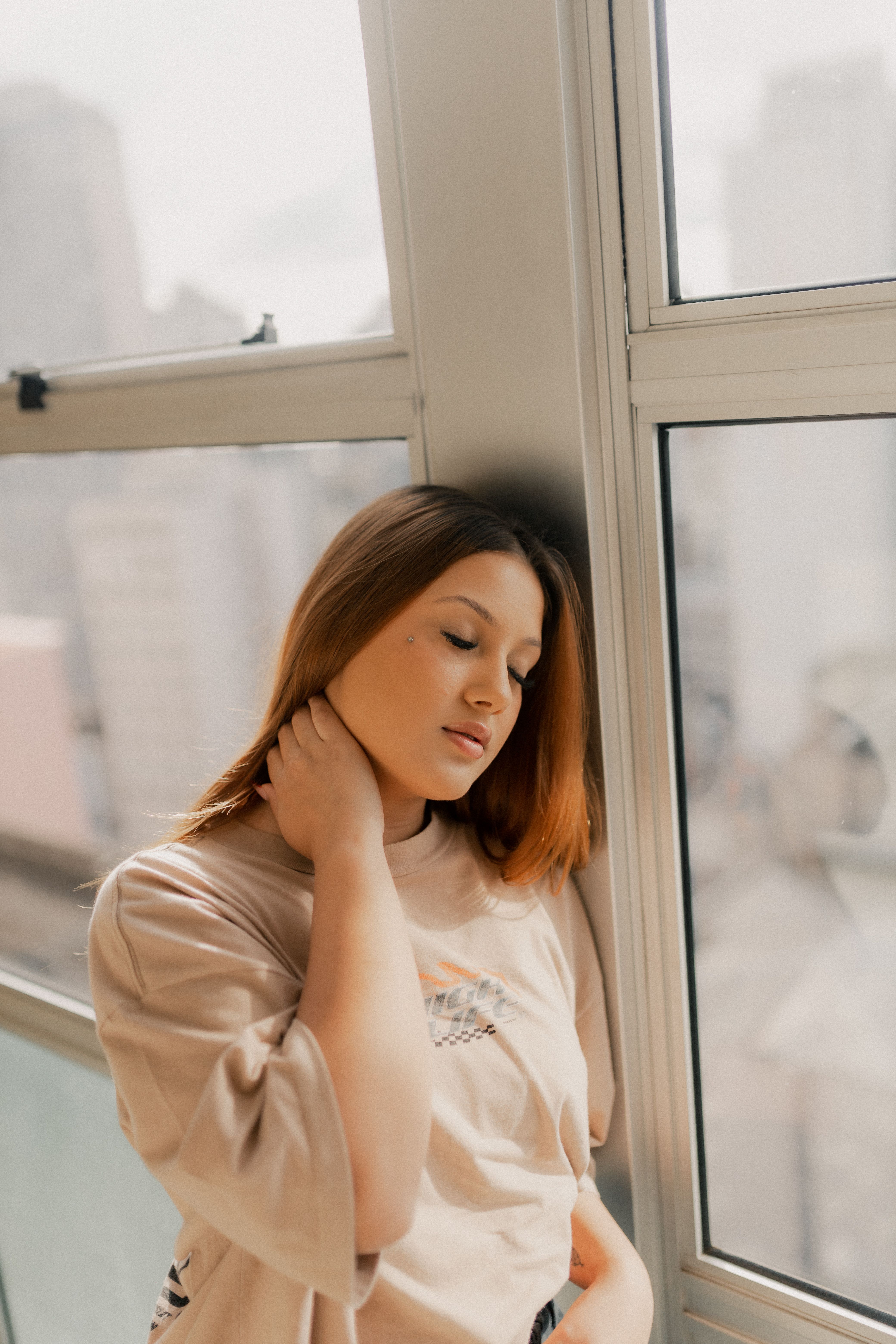 Contemplative Woman by Sunlit Window · Free Stock Photo
